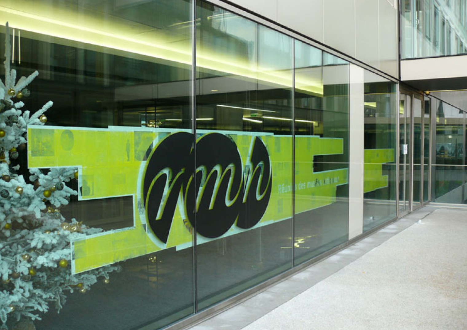 Green lettering on a glazed façade.