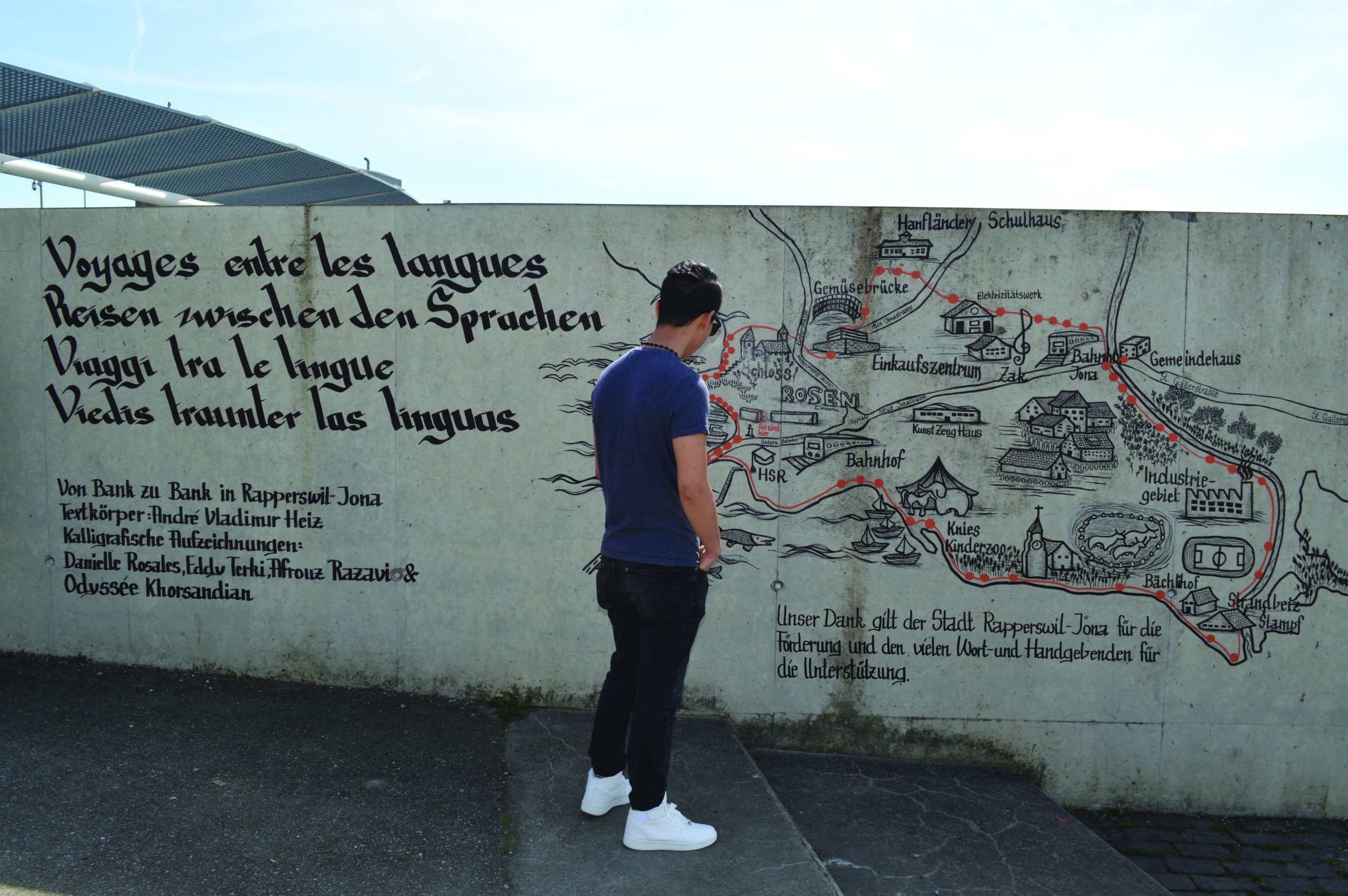 Person in front of the map and lettering.