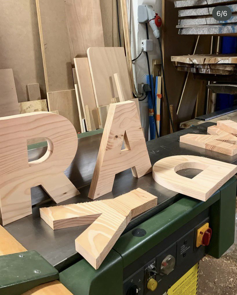 Wooden letters on a workbench.