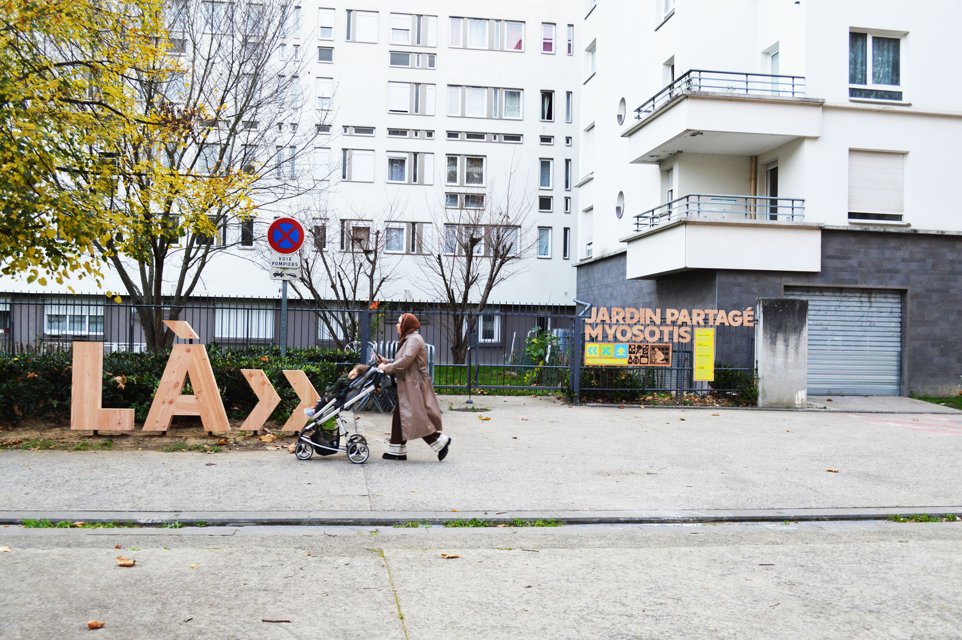 Wooden letters in front of a fence.